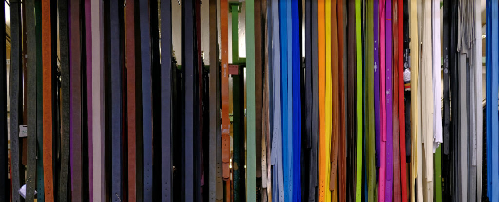 A colourful selection of belts, hanging in the Hepco Manufactory in Germany